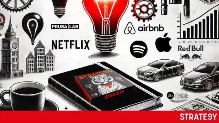 a black box with a red light bulb and a book